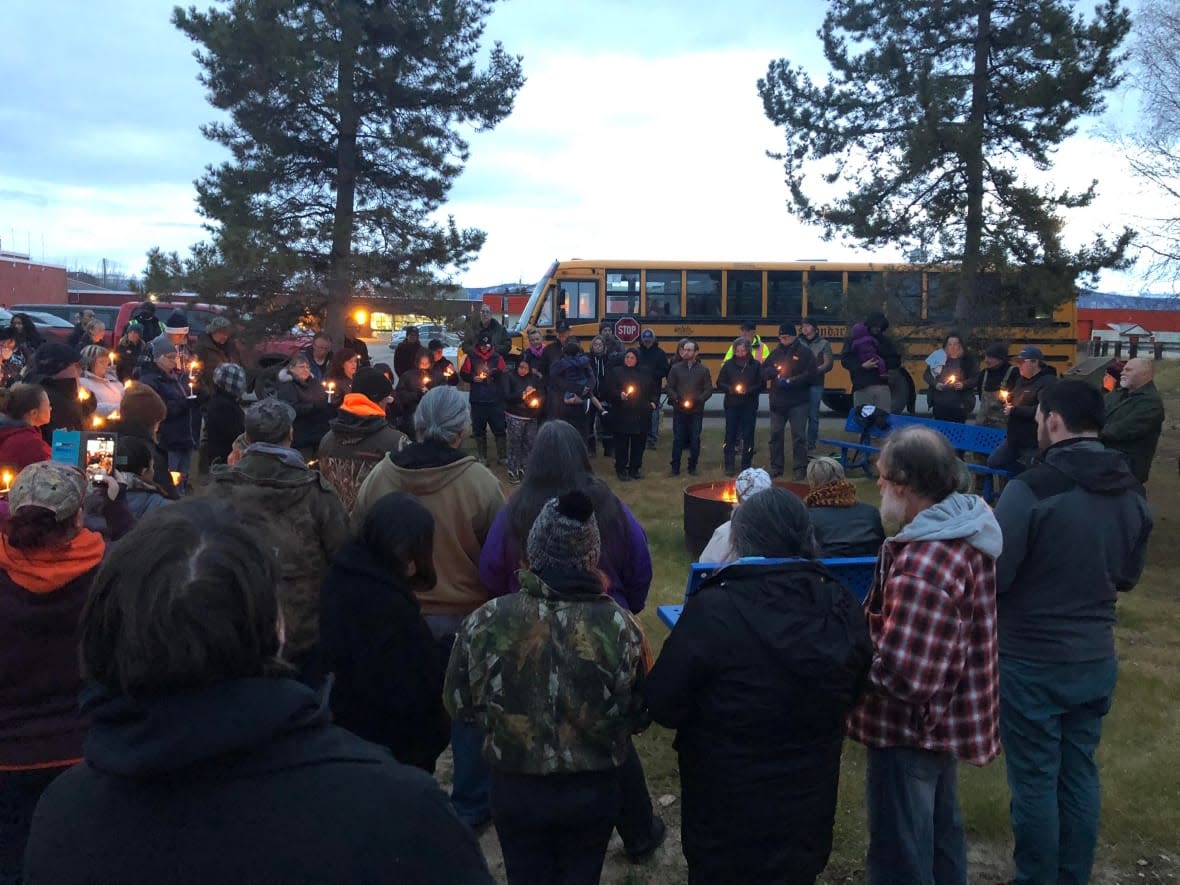 Dozens of people gathered Wednesday evening in Faro, Yukon, to honour the victims killed and hurt by a gunman in the community a day earlier. Two people were killed and another injured. A local man is facing murder, attempted murder and assault charges.   (Mike Rudyk/CBC - image credit)