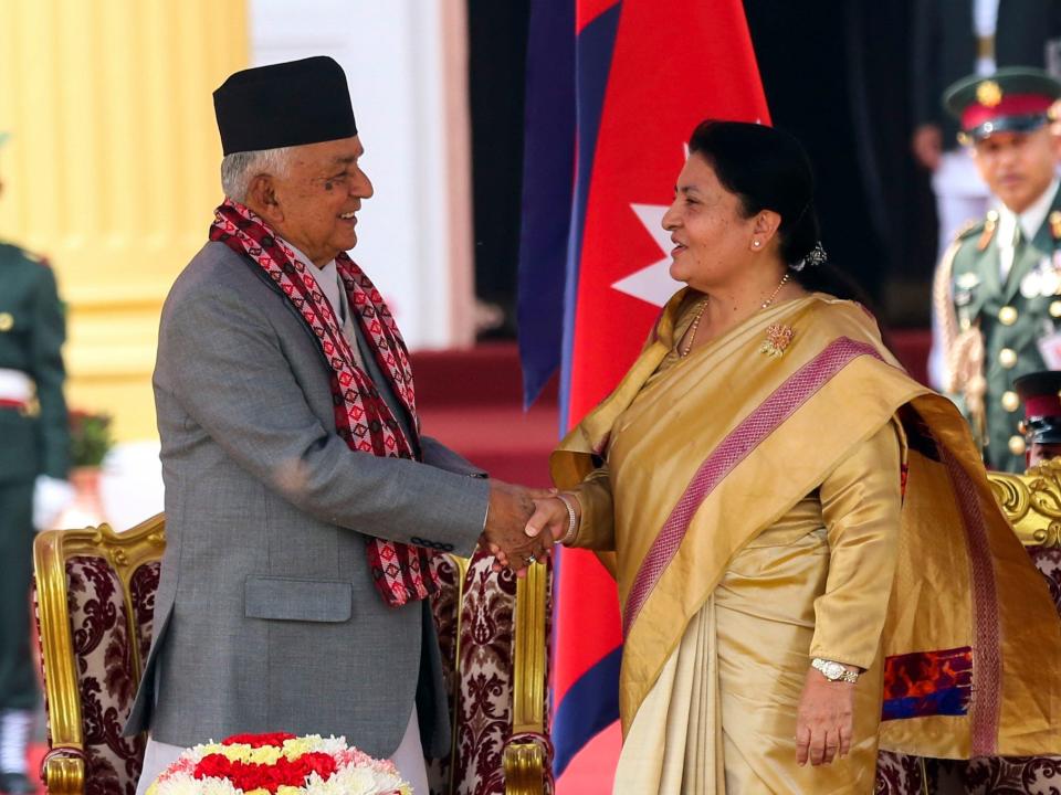 Outgoing President Bidhya Devi Bhandari, right, congratulates Nepal's newly elected president Ram Chandra Poudel, after he took the oath of office at the presidential building 