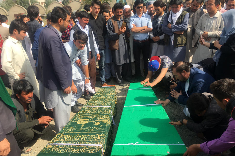 Relatives pray near to the dead bodies of civilians after Wednesday's deadly suicide bombing that targeted a training class in a private building in the Shiite neighborhood of Dasht-i Barcha, in western Kabul, Afghanistan, Thursday, Aug. 16, 2018. (AP Photo/Rahmat Gul)