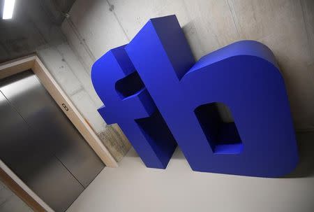 FILE PHOTO: A giant logo is seen at Facebook's headquarters in London, Britain, December 4, 2017. REUTERS/Toby Melville