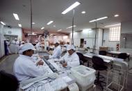 Employees work on condoms in a factory in Buenos Aires