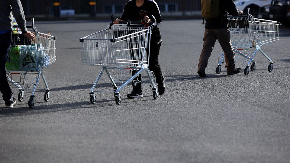 Customers push shopping carts outside a Lidl Stiftung & Co. KG supermarket in Berlin, Germany, on Tuesday, Oct. 4, 2022. - Krisztian Bocsi/Bloomberg/Getty Images