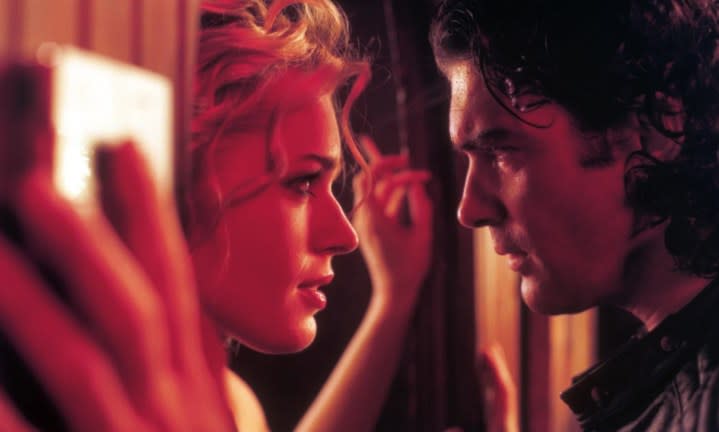 A man and a woman gaze at each other in Femme Fatale.