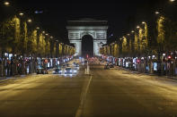 Champs-Elysees avenue is almost empty during curfew in Paris, Saturday, Oct. 17, 2020. French restaurants, cinemas and theaters are trying to figure out how to survive a new curfew aimed at stemming the flow of record new coronavirus infections. The monthlong curfew came into effect Friday at midnight, and France is deploying 12,000 extra police to enforce it. (AP Photo/Lewis Joly)