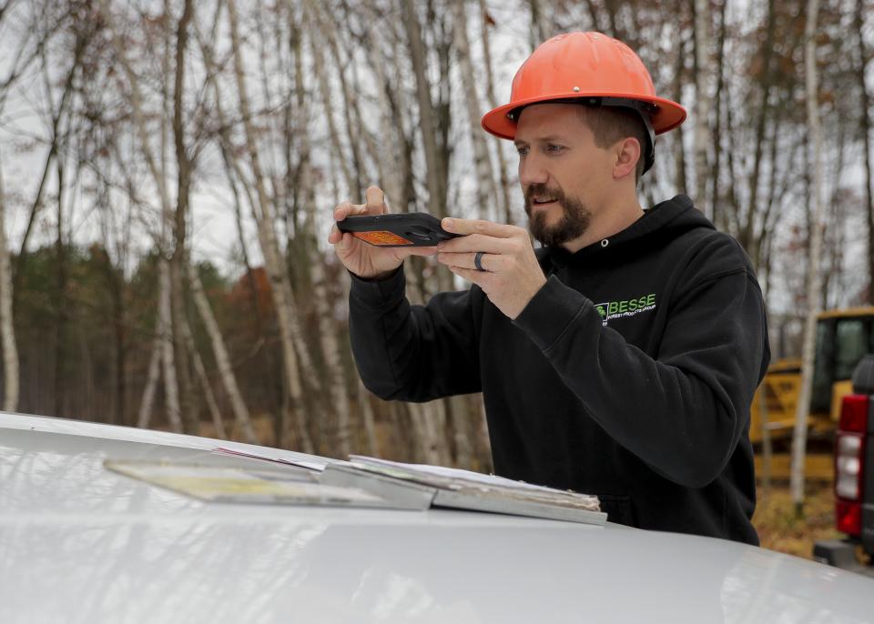 Forester Matt Carothers scans a field inspection report on Monday, October 24, 2022, near Minocqua, Wis.