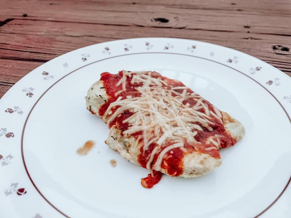 piece of chicken parmesan on a kitchen plate