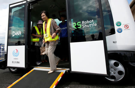 Local residents get off from Robot Shuttle, a driver-less, self driving bus, developed by Japan's internet commerce and mobile games provider DeNA Co., during an experimental trial with a self-driving bus in a community in Nishikata town, Tochigi Prefecture, Japan September 8, 2017. REUTERS/Issei Kato