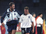 FILE - In this July 4, 1990 file photo England's Paul Gascoigne cries as he is escorted off the field by team captain Terry Butcher, after England lost a penalty shoot-out in the semi-final match of the World Cup against West Germany in Turin, Italy. (AP Photo/Roberto Pfeil, File)