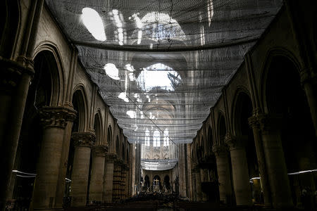 A picture shows a protective net inside the Notre-Dame Cathedral during the preliminary work in the Notre-Dame Cathedral one month after it sustained major fire damage in Paris, France May 15, 2019. Philippe Lopez/Pool via REUTERS