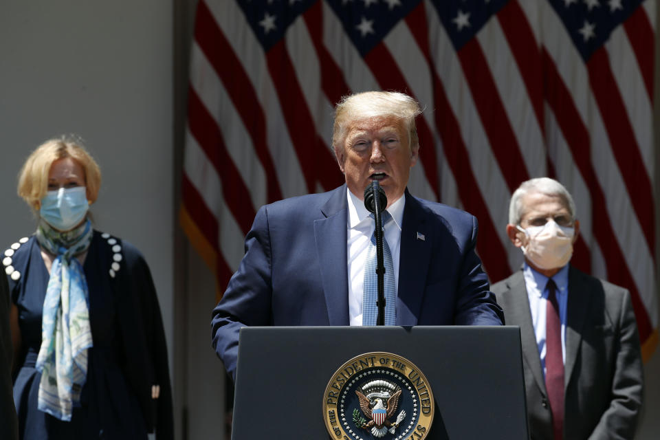 President Donald Trump speaks about the coronavirus in the Rose Garden of the White House, Friday, May 15, 2020, in Washington. Dr. Anthony Fauci, director of the National Institute of Allergy and Infectious Diseases, right, and White House coronavirus response coordinator Dr. Deborah Birx listen.  (Photo: ASSOCIATED PRESS)