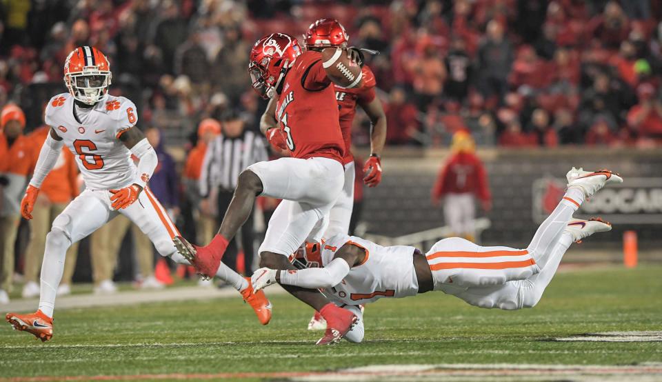 Clemson safety Andrew Mukuba (1) upends Louisville quarterback Malik Cunningham (3) on a third down play during the fourth quarter at Cardinal Stadium in Louisville, Kentucky Saturday, November 6, 2021.