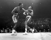 FILE - In this March 8, 1971, file photo, boxer Joe Frazier, left, hits Muhammad Ali during the 15th round of their heavyweight title fight at New York's Madison Square Garden. (AP Photo/File)