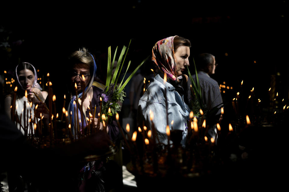 Women attend a Mass at the St. Volodymyr's Cathedral during Orthodox Pentecost, in Kyiv, Ukraine, Sunday, June 12, 2022. (AP Photo/Natacha Pisarenko)