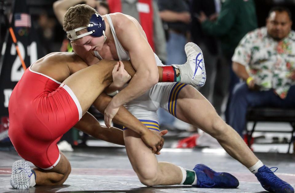 Bremerton’s Lars Michaelson takes first place over Prosser’s Nehemiah Medrona in their 182-pound championship bout during Mat Classic Championships at the Tacoma Dome on Saturday, Feb. 18, 2023. 