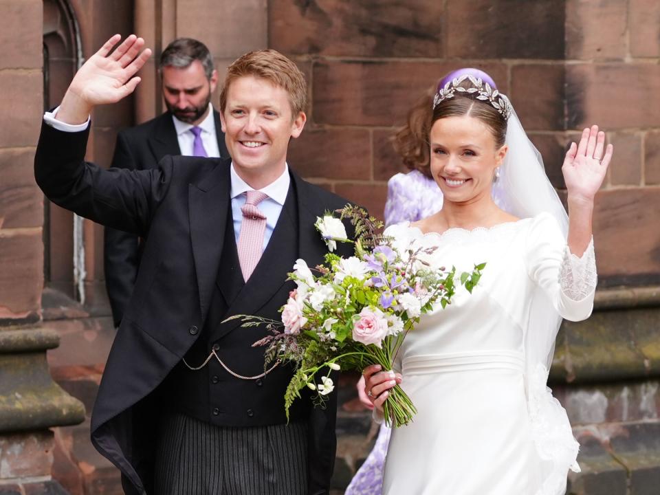 Olivia Henson and Hugh Grosvenor, the Duke of Westminster waving to the crowds (Peter Byrne/PA)