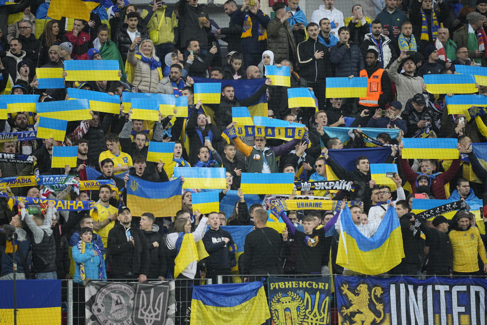 Supporters wave Ukraine's flags before the Euro 2024 group C qualifying soccer match between Ukraine and Italy at the BayArena in Leverkusen, Germany, Monday, Nov. 20, 2023. (AP Photo/Martin Meissner)