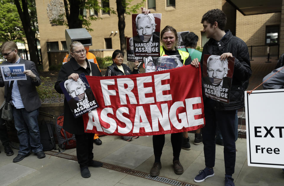 Protesters outside court as Julian Assange will appear to be sentenced on charges of jumping British bail seven years ago, in London, Wednesday May 1, 2019. Founder of WikiLeaks whistleblower website, Assange faces a separate court hearing later, on a U.S. extradition request, after being arrested at the Ecuadorian embassy April 11, when his political asylum was withdrawn. (AP Photo/Matt Dunham)