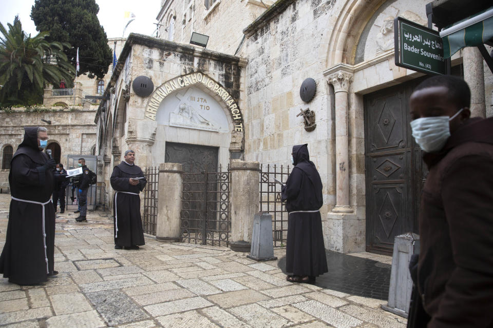 Franciscan friars retrace the Via Dolorosa in Jerusalem's Old City on Friday after the traditional mass procession was called off amid coronavirus fears, in Jerusalem, Friday, April 10, 2020. Christians are commemorating Jesus' crucifixion without the solemn church services or emotional processions of past years, marking Good Friday in a world locked down by the coronavirus pandemic.(AP Photo/Sebastian Scheiner)