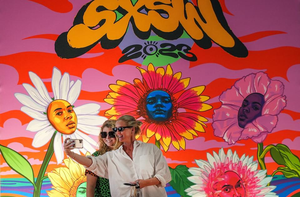 Samantha Gadd and Jenny Busing of New Zealand take selfies after getting their South by Southwest badges at the Austin Convention Center on Wednesday. The annual festival kicks off Friday.