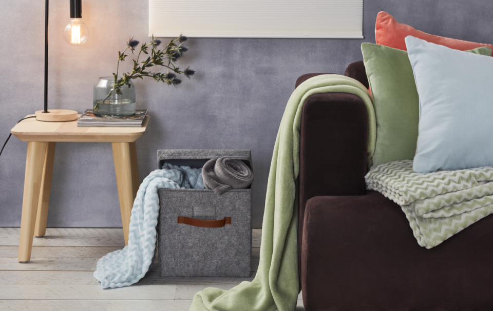 Pictured: Coles Your Home lamp, cushions and throw rugs. Image: Coles