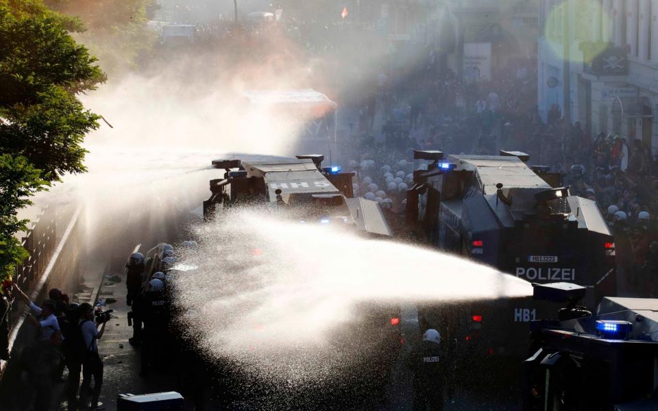 German riot police use water cannons against protesters during the demonstrations during the G20 summit in Hamburg - Credit: Reuters