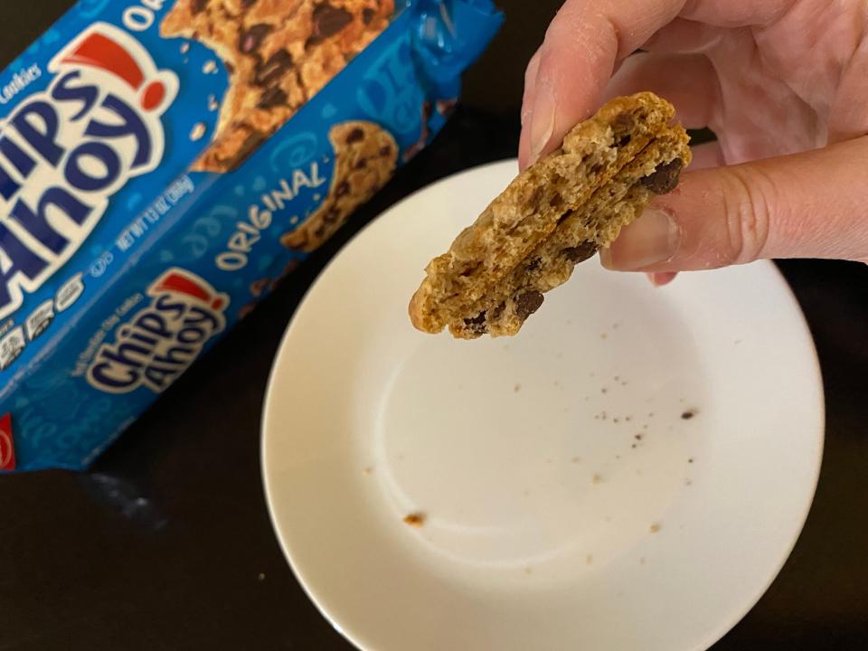 hand holding two pieces of chips ahoy cookies