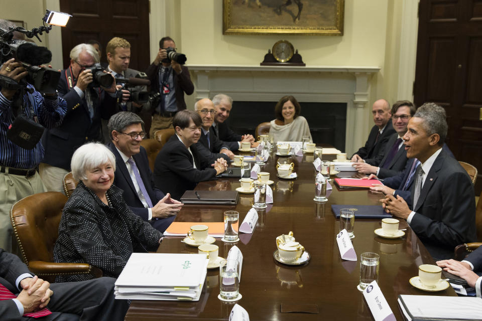 FILE - In this Oct. 6, 2014, file photo President Barack Obama sits across the table from Federal Reserve Chair Janet Yellen, left, and Treasury Secretary Jacob Lew during a meeting with financial regulators in the Roosevelt Room of the White House in Washington. (AP Photo/Evan Vucci, File)