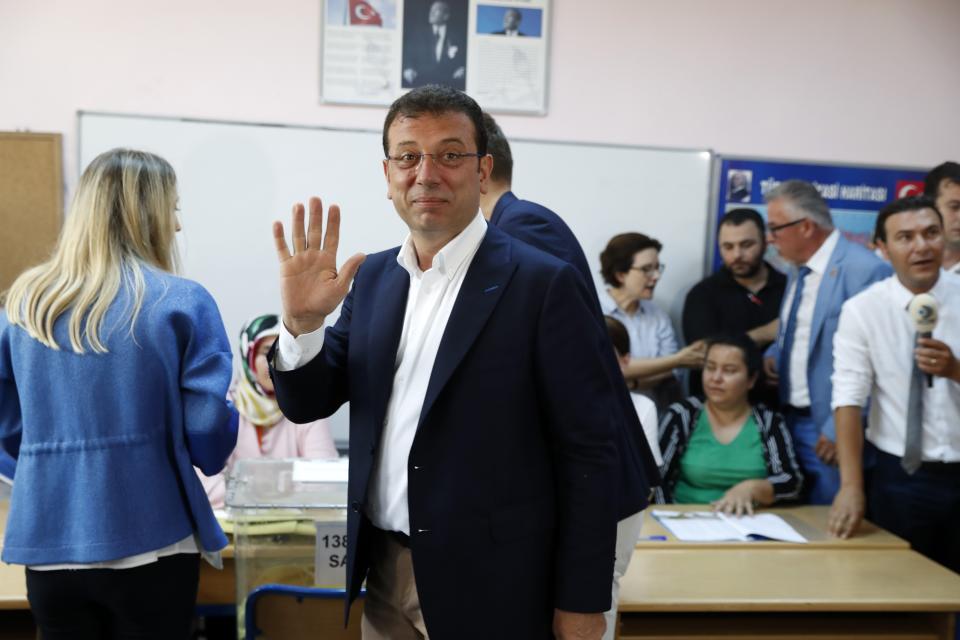 Ekrem Imamoglu, candidate of the secular opposition Republican People's Party, or CHP waves to the media at a polling station in Istanbul, Sunday, June 23, 2019. Voters in Istanbul returned to the polls Sunday for a re-run mayoral election ordered up by authorities after President Recep Tayyip Erdogan and his political allies lost control of Turkey's largest city for the first time in 25 years. (AP Photo/Lefteris Pitarakis)