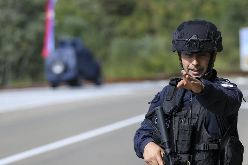 A Kosovo police officer guards a road near the village of Banjska in northern Kosovo. <a href="https://newsroom.ap.org/detail/KosovoSerbiaTension/c26eccb374754e3db37a3bc2e6a15ce4/photo?Query=serbia%20war&mediaType=photo&sortBy=arrivaldatetime:desc&dateRange=Anytime&totalCount=6098&currentItemNo=46" rel="nofollow noopener" target="_blank" data-ylk="slk:AP Photo/Bojan Slavkovic;elm:context_link;itc:0;sec:content-canvas" class="link ">AP Photo/Bojan Slavkovic</a>