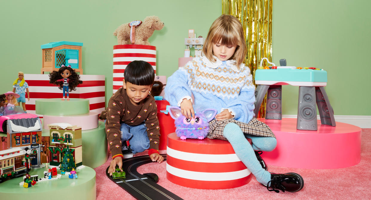 Two young children playing with John Lewis' best toys for 2023