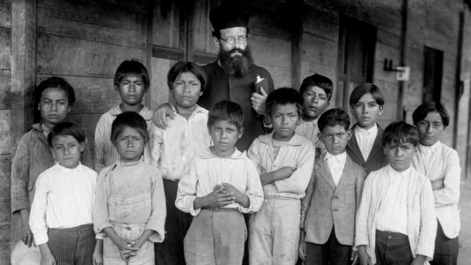 <div class="inline-image__caption"><p>Missionary with indigenous Shuar children from Gualaquiza, Morona Santiago, Anya Yala Cultural Center (circa 1925- 1935) from <em>Exterminate All the Brutes</em></p></div> <div class="inline-image__credit">HBO</div>