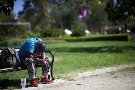 A homeless man sleeps on a park bench in Logan Square on the Benjamin Franklin Parkway in Philadelphia, Pennsylvania, in this September 23, 2015, file photo. REUTERS/Mark Makela/Files