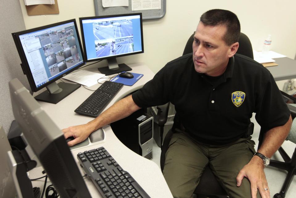 In this photo taken Tuesday, July 17, 2012, Vallejo police Sgt. Mark Nicol monitors video displays of the high definition surveillance cameras that are dotted around Vallejo, Calif. In 2008 Vallejo declared bankruptcy, forcing cuts to many city services including the reduction of the police force from 155 to 90 officers. To fill the loss the cameras were installed and are often monitored by citizen volunteers. (AP Photo/Rich Pedroncelli)