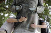 <p>Workers wrap protective materials around a statue of Confederate President Jefferson Davis as they prepare to move the sculpture on the University of Texas campus, Sunday, Aug. 30, 2015, in Austin, Texas. The Davis statue will be moved and placed in the school’s Dolph Briscoe Center for American History as part of an educational display. (Photo: Eric Gay/AP) </p>