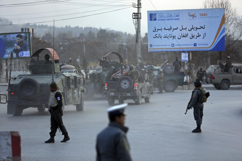 Afghan security forces arrive at the site of an explosion and attack by gunmen, in Kabul, Afghanistan, Monday, Dec. 24, 2018. (AP Photo/Rahmat Gul)