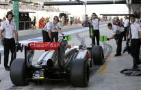 McLaren Formula One driver Jenson Button of Britain makes a pit stop during the third practice session of the Abu Dhabi F1 Grand Prix at the Yas Marina circuit on Yas Island, November 2, 2013. REUTERS/Ahmed Jadallah (UNITED ARAB EMIRATES - Tags: SPORT MOTORSPORT F1)