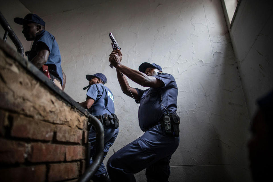 <p>Police officers raid a building where alleged foreign drug dealers are hiding in Pretoria, South Africa, Feb. 24, 2017. (Photo: Marco Longari/AFP/Getty Images) </p>