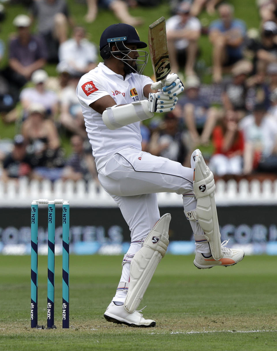 Sri Lanka's Dimuth Karunaratne hits the ball to the boundary during play on day one of the first cricket test against New Zealand in Wellington, New Zealand, Saturday, Dec. 15, 2018. (AP Photo/Mark Baker)