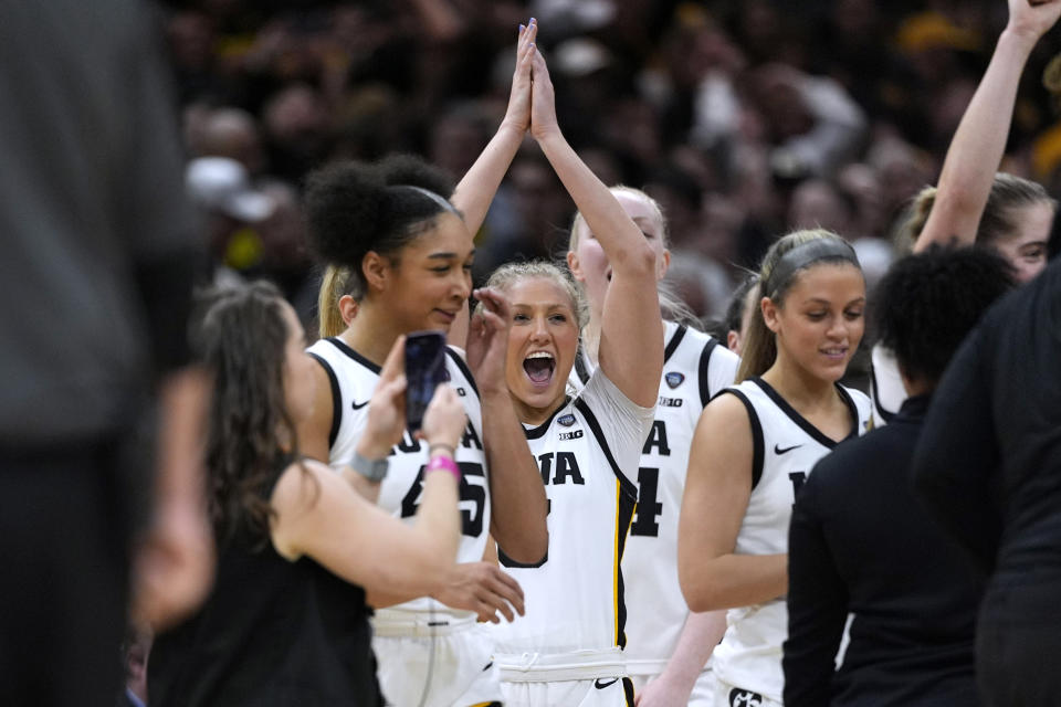 Iowa guard Sydney Affolter, center, celebrates at the end of a Final Four college basketball game against UConn in the women's NCAA Tournament, Friday, April 5, 2024, in Cleveland. Iowa won 71-69. (AP Photo/Carolyn Kaster)