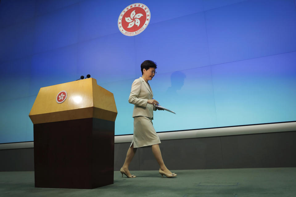 FILE - In this Tuesday, June 18, 2019, file photo, Hong Kong Chief Executive Carrie Lam leaves after a press conference at the Legislative Council in Hong Kong. Many analysts expect Lam will eventually step down to take responsibility for the mess resulting from her effort to fast-track the extradition bill, which would allow some suspects in Hong Kong to be tried in mainland Chinese courts. (AP Photo/Kin Cheung, File)