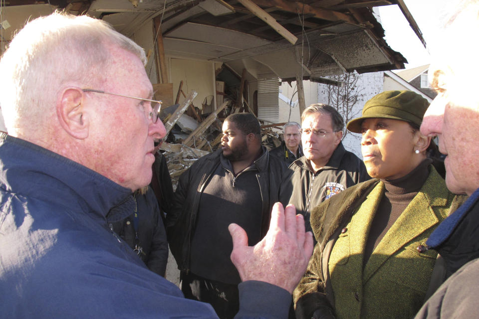 Mantoloking N.J. Mayor George Nebel, left, speaks with then-New Jersey Assembly speaker Sheila Oliver, right, during a tour of his devastated town one month after Superstorm Sandy hit, Nov. 29, 2012, in Mantoloking, N.J.. Oliver, who went on to become New Jersey's lieutenant governor, died Aug. 1, 2023, at age 71. (AP Photo/Wayne Parry)