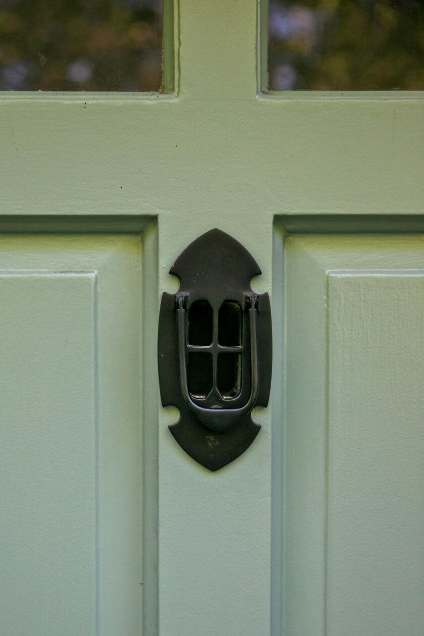 A closeup of the door knocker on the front door of the Ivanhoe Vista house.