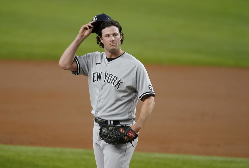 FILE - New York Yankees' Gerrit Cole pauses during the team's baseball game against the Texas Rangers in Arlington, Texas, May 17, 2021. Sometime soon, lockout costs become real: Max Scherzer would forfeit $232,975 for each regular-season day lost and Cole $193,548. Based on last year’s base salaries that totaled just over $3.8 billion, major league players would combine to lose $20.5 million for each day wiped off the 186-day regular season schedule. (AP Photo/Tony Gutierrez, File)