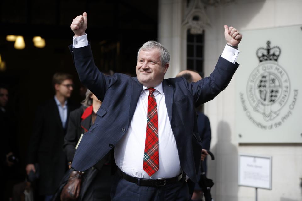 Scottish National Party (SNP) Westminster leader Ian Blackford raises his arms as he comes out to speak to the media outside the Supreme court in central London on September 24, 2019 after the judgement of the court on the legality of Boris Johnson's advice to the Queen to suspend parliament for more than a month, as the clock ticks down to Britain's October 31 EU exit date. - Britain's Supreme Court on September 24 said that parliamentarians could reconvene "as soon as possible" after ruling that a decision by Prime Minister Boris Johnson to suspend parliament was unlawful. (Photo by Tolga AKMEN / AFP)        (Photo credit should read TOLGA AKMEN/AFP/Getty Images)