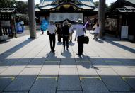 Markers indicating social distancing for visitors are displayed on the approach to the main shrine of Yasukuni Shrine for the war dead, in Tokyo