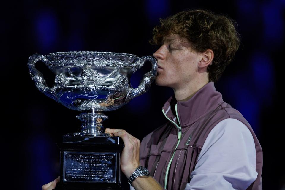 Jan 28, 2024; Melbourne, Victoria, Australia; Jannik Sinner of Italy celebrates with the winner’s trophy, after defeating Daniil Medvedev of Russia in the men’s singles final at the Australian Open. Mandatory Credit: Mike Frey-USA TODAY Sports