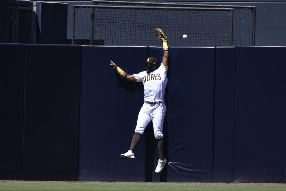 San Diego Padres center fielder Jorge Mateo is unable to make a catch for a two-run home run by San Francisco Giants' Darin Ruf during the second inning of a baseball game in San Diego, Wednesday, April 7, 2021. (AP Photo/Kelvin Kuo)