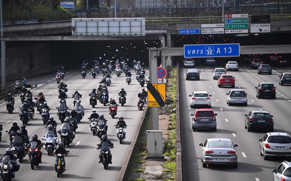 Motorcyclists ride in groups on a Paris ring-road - AFP