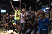 Frances Tiafoe's supporters react as they watch the U.S. Open Tennis game between Tiafoe and Carlos Alcaraz during a watch party in College Park, Md., Friday, Sept. 9, 2022. (AP Photo/Jose Luis Magana)