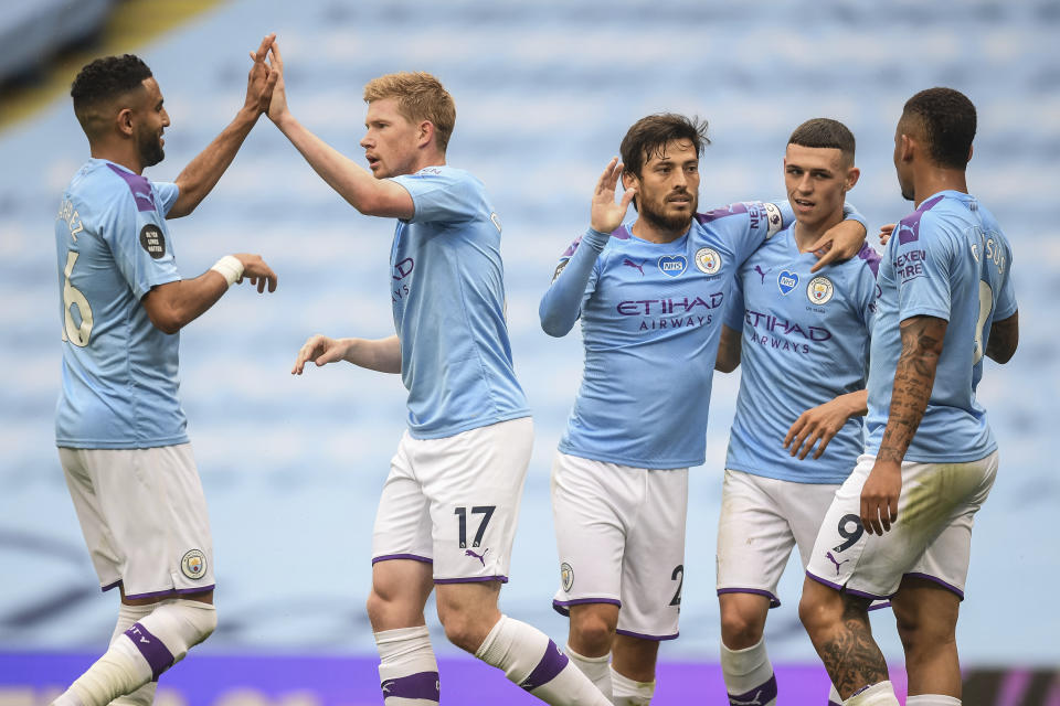 Manchester City players celebrate after scoring their second goal during the English Premier League soccer match between Manchester City and Newcastle at the Ethiad Stadium in Manchester, England, Wednesday, July 8, 2020. (Michael Regan/Pool via AP)